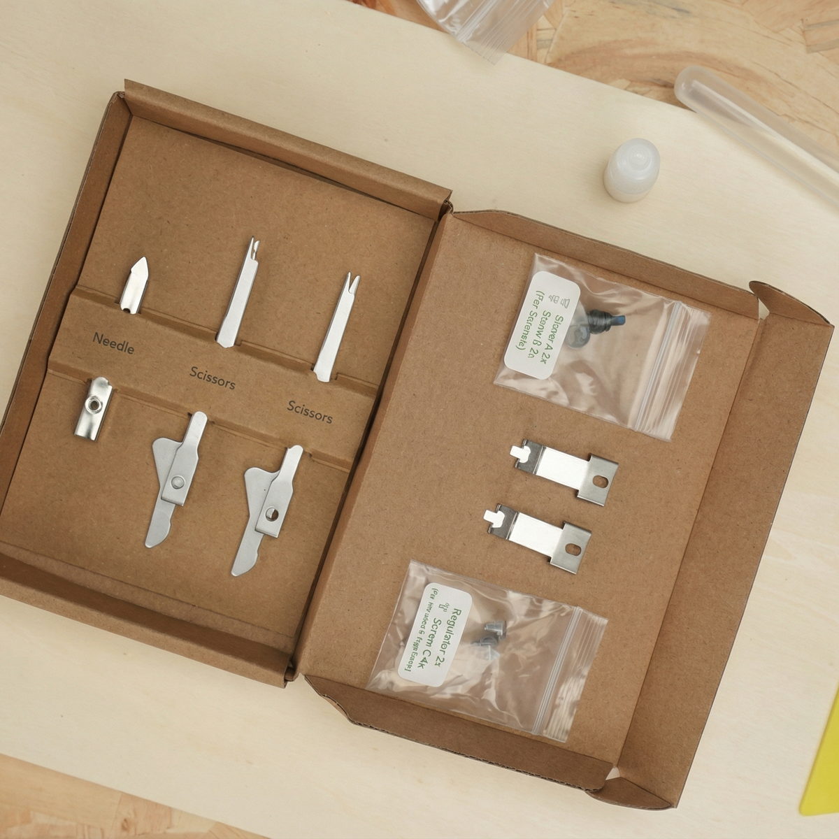 Clawlab Start Kit: Organized metal needle, scissor components, regulators, and screws.