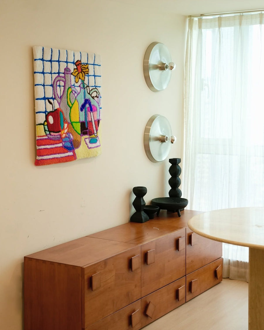 This colorful tufted wall piece brings a little more warmth and character to the room.