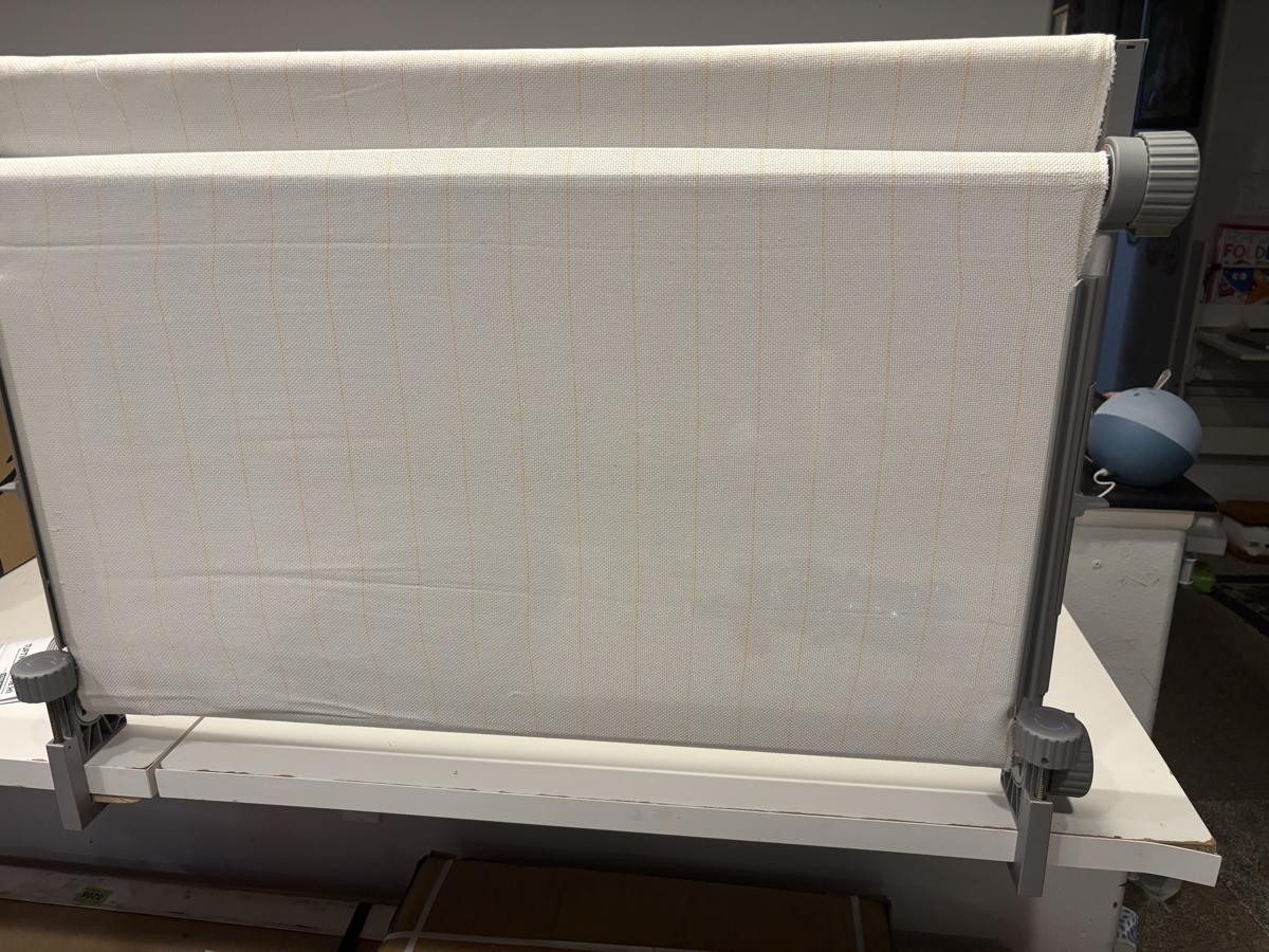Clawlab nail-free tufting frame with white grid fabric and adjustable tension knobs.